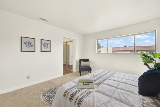 bedroom featuring light carpet