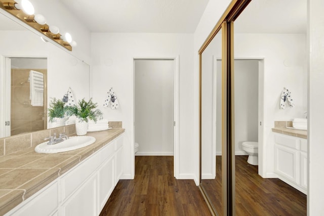 bathroom featuring hardwood / wood-style flooring, vanity, and toilet