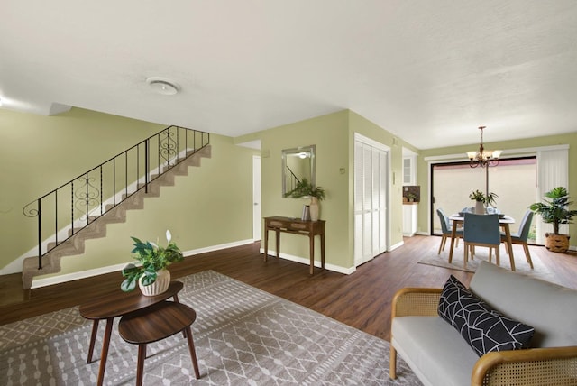 living room with an inviting chandelier and wood-type flooring