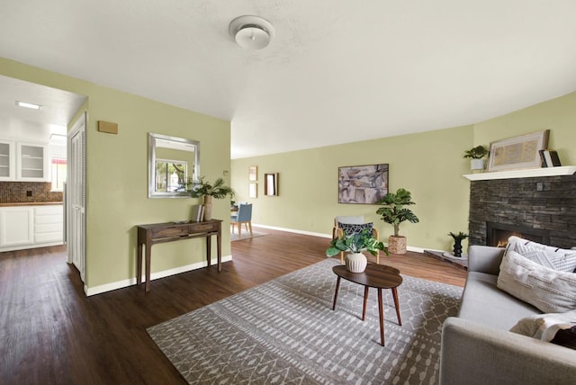 living room with dark hardwood / wood-style floors and a fireplace