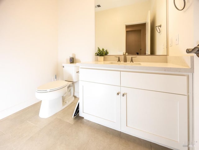 half bath with toilet, tile patterned floors, visible vents, and vanity