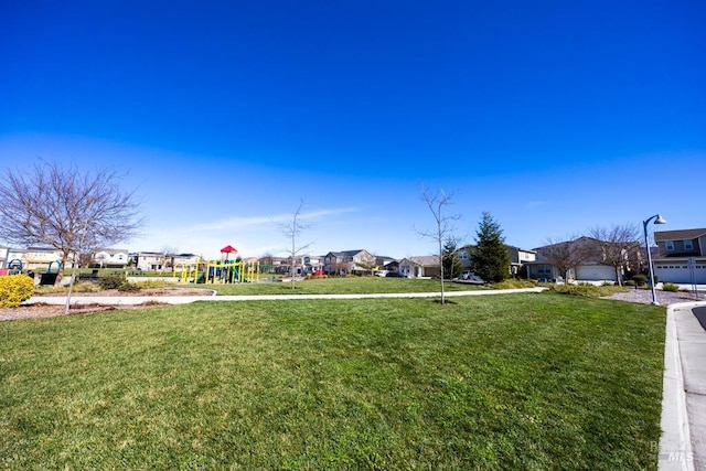 view of yard featuring a residential view and playground community