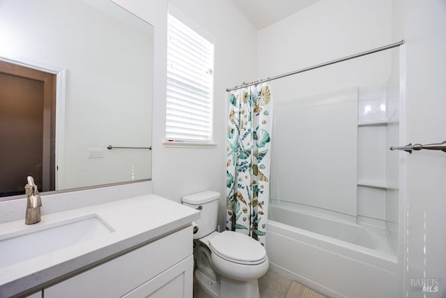 bathroom featuring toilet, shower / bath combo with shower curtain, and vanity