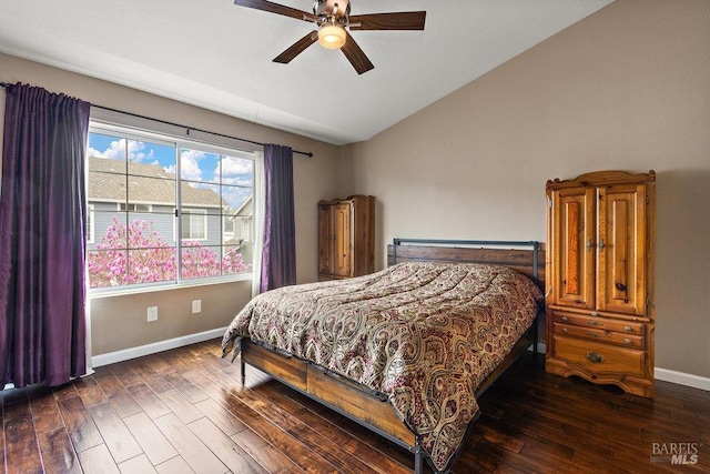 bedroom featuring vaulted ceiling, dark hardwood / wood-style floors, and ceiling fan