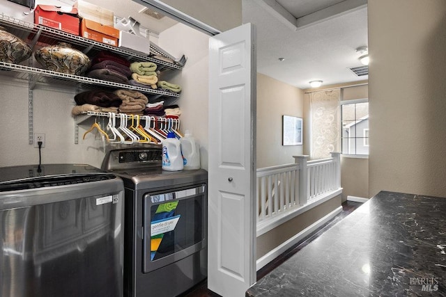 clothes washing area with washer and dryer