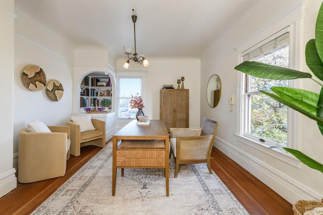 dining area featuring plenty of natural light, a chandelier, and wood finished floors