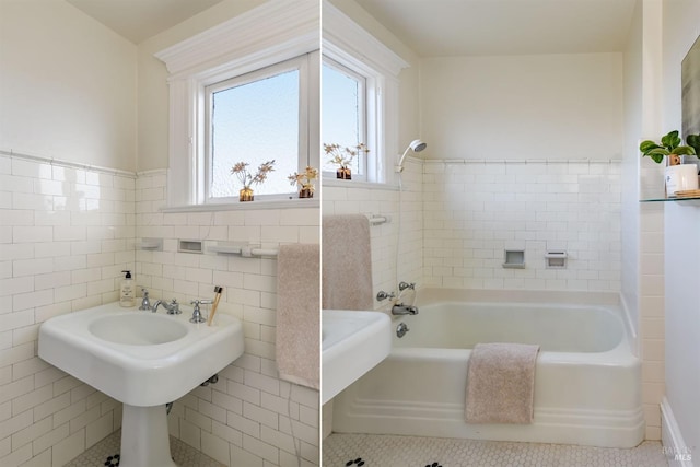 bathroom with tile walls, a bathtub, tile patterned flooring, and wainscoting