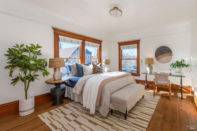 bedroom featuring light wood-type flooring and baseboards