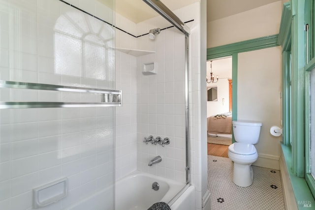 full bath featuring toilet, shower / bath combination, a chandelier, and tile patterned floors