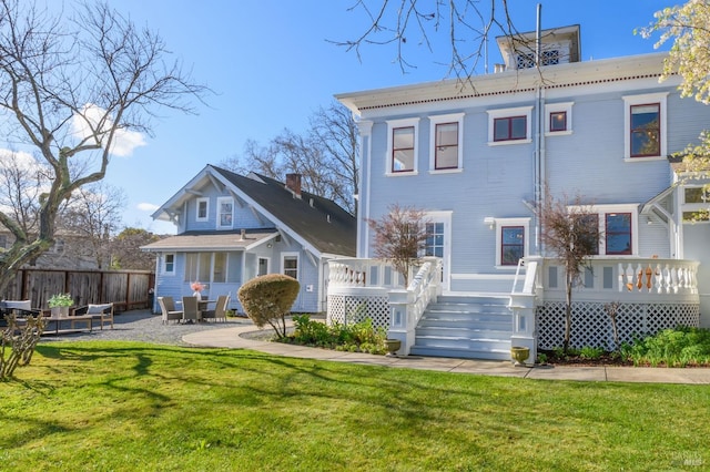 rear view of property featuring a deck