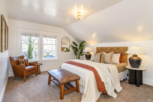 bedroom featuring baseboards, carpet flooring, and lofted ceiling