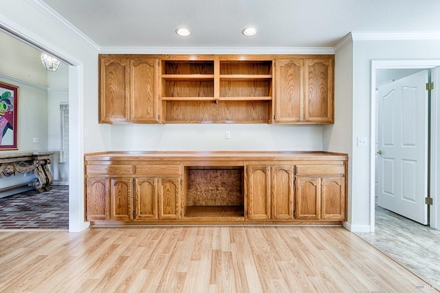 unfurnished office featuring baseboards, light wood-type flooring, crown molding, and recessed lighting