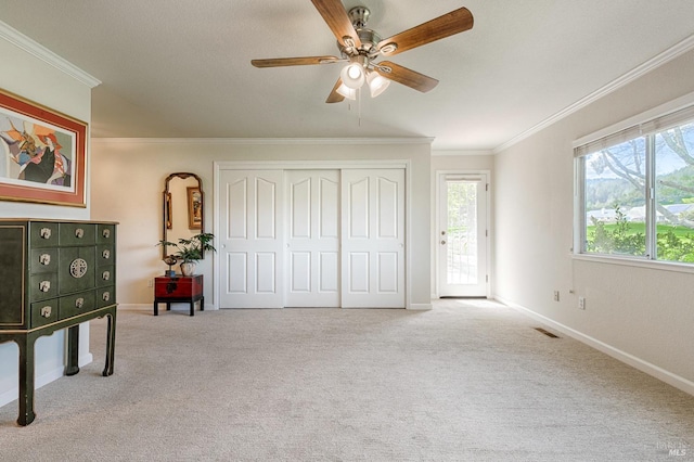 unfurnished bedroom featuring baseboards, carpet flooring, ornamental molding, and access to exterior