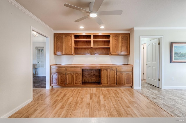 kitchen featuring crown molding, light wood finished floors, brown cabinets, a ceiling fan, and open shelves