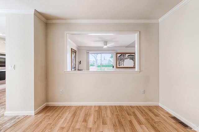 unfurnished room with visible vents, baseboards, ornamental molding, wood finished floors, and a ceiling fan