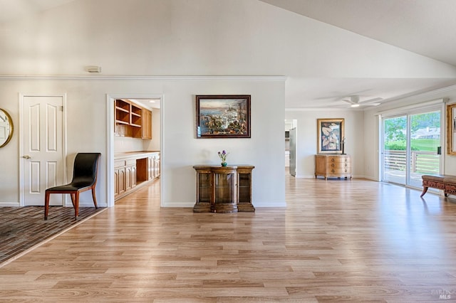unfurnished living room with baseboards, high vaulted ceiling, light wood-style flooring, and ceiling fan