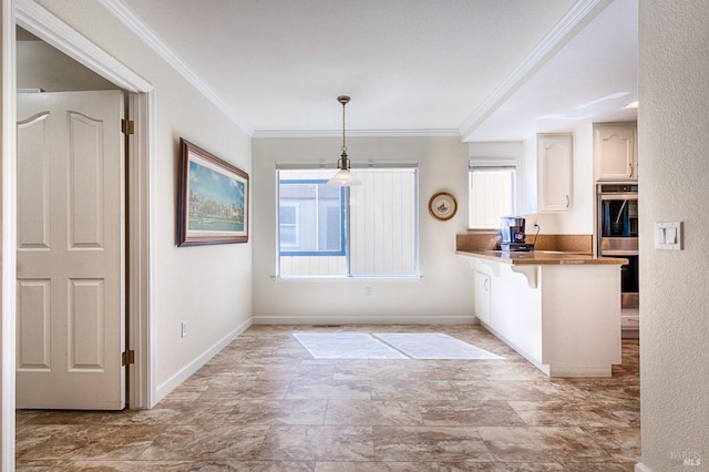kitchen with stainless steel double oven, ornamental molding, a breakfast bar area, and pendant lighting
