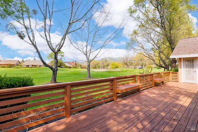 wooden deck with a lawn