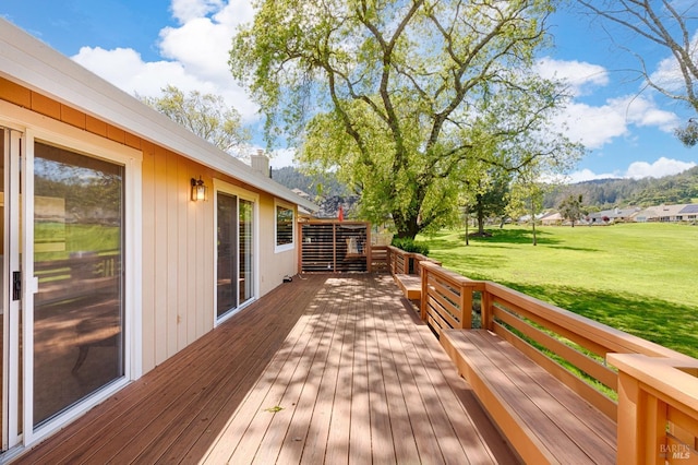 wooden deck with a lawn