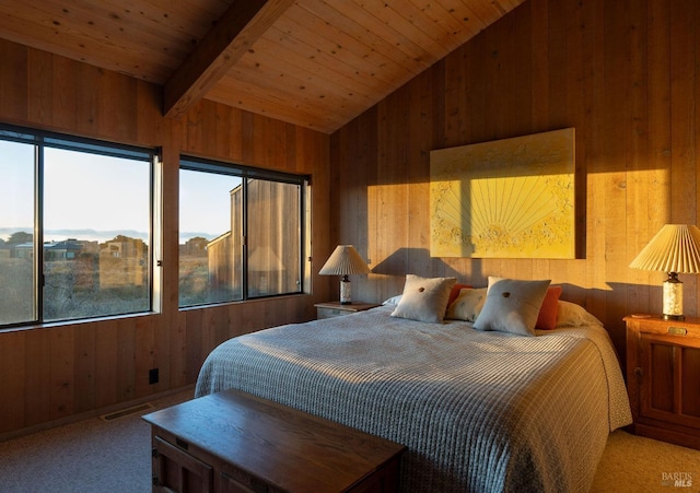 bedroom with wood ceiling, wood walls, carpet, and vaulted ceiling with beams