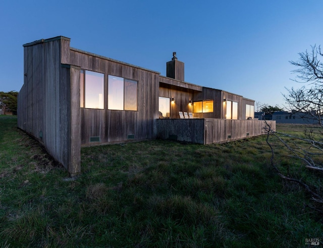 back of house featuring a yard