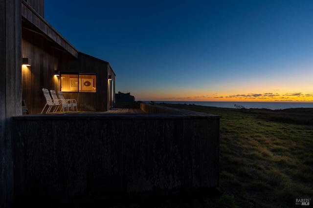 yard at dusk with a water view