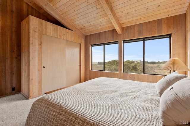 bedroom featuring carpet flooring, vaulted ceiling with beams, wood ceiling, and wood walls