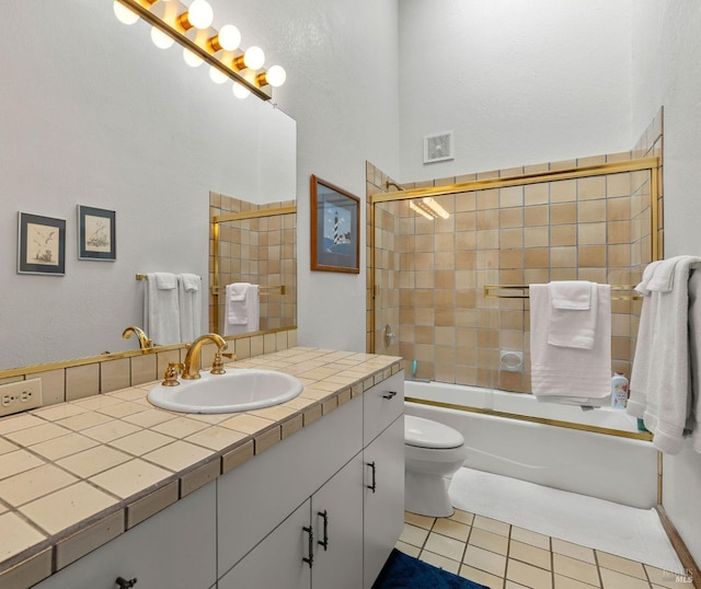 full bathroom with vanity, tile patterned floors, enclosed tub / shower combo, and toilet