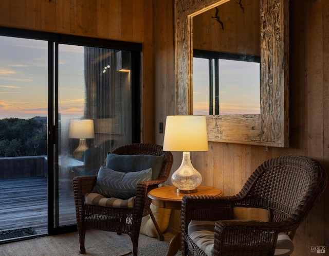 sitting room featuring wooden walls