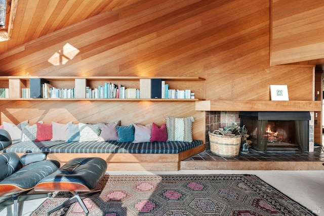 living room featuring a fireplace and wood walls