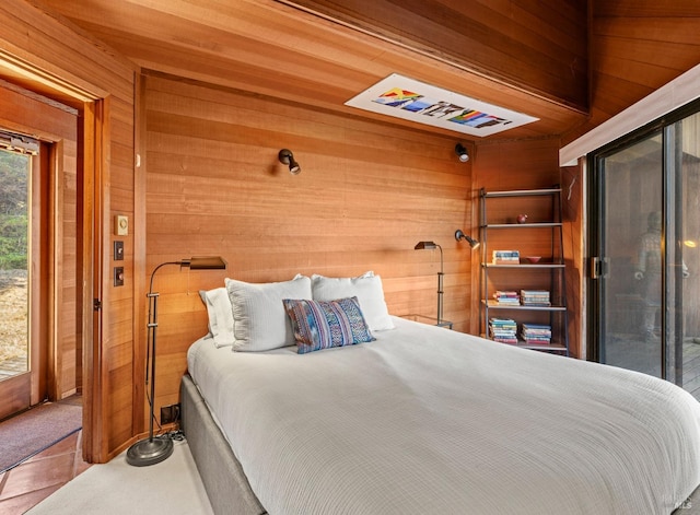 bedroom featuring wood walls