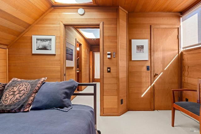 carpeted bedroom featuring wood walls, vaulted ceiling, and wooden ceiling