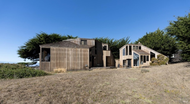 back of house with an outdoor structure