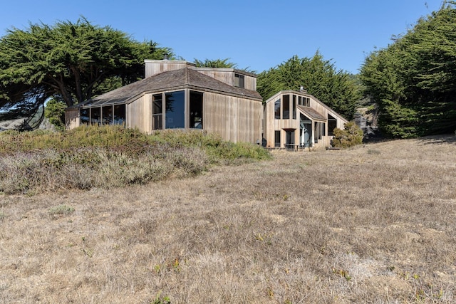 view of home's exterior with an outdoor structure