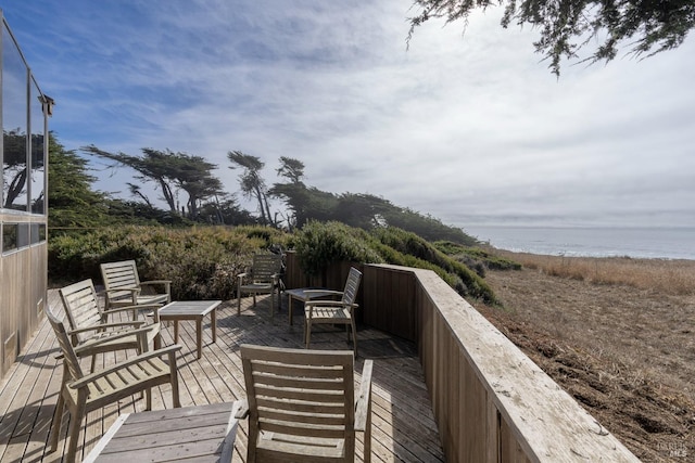 wooden deck featuring a water view