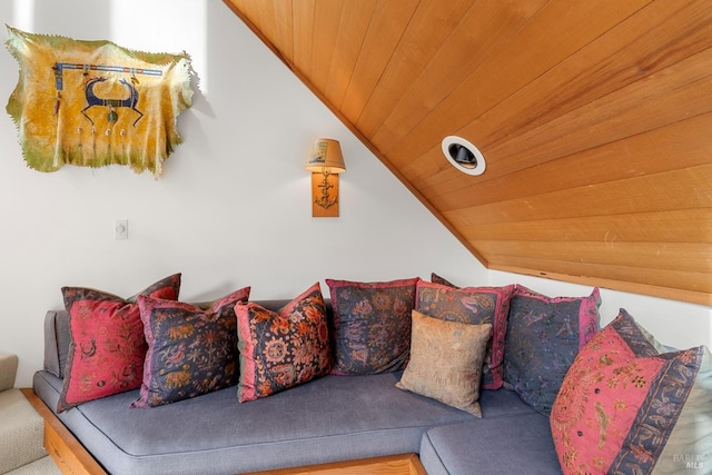 carpeted living room featuring lofted ceiling and wooden ceiling