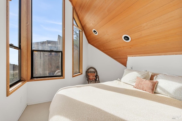 carpeted bedroom featuring vaulted ceiling, multiple windows, and wooden ceiling