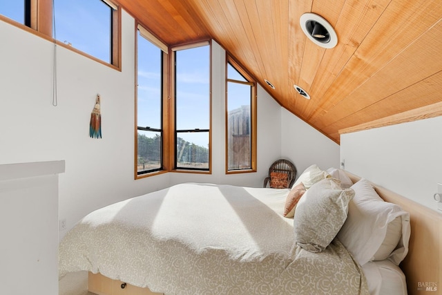 bedroom featuring lofted ceiling and wooden ceiling