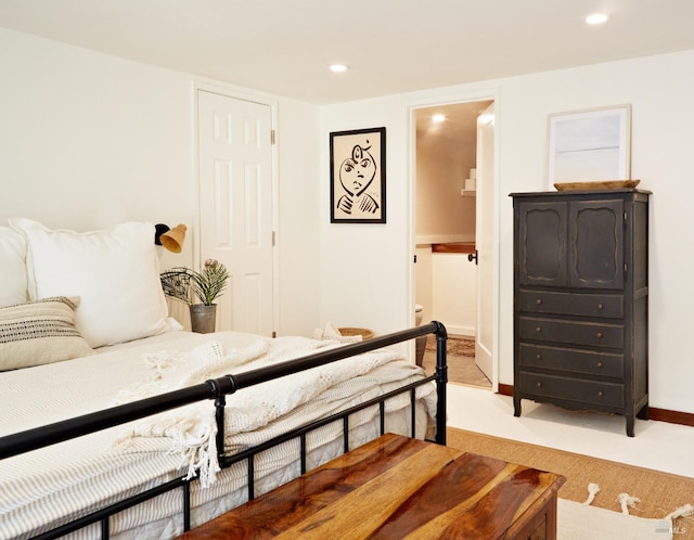 bedroom featuring baseboards, recessed lighting, connected bathroom, and light colored carpet