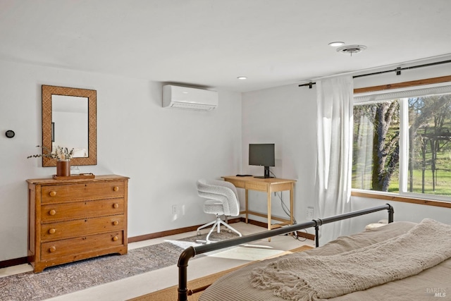 bedroom featuring a wall mounted AC, visible vents, and baseboards