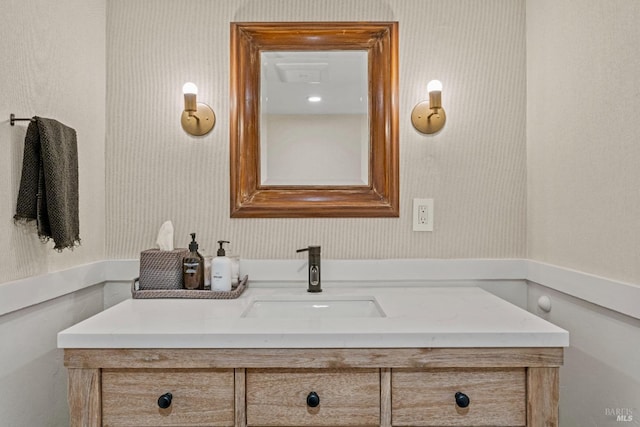 bathroom featuring wallpapered walls and vanity