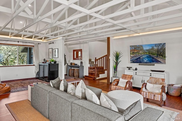 living area with stairs, baseboards, coffered ceiling, and wood finished floors