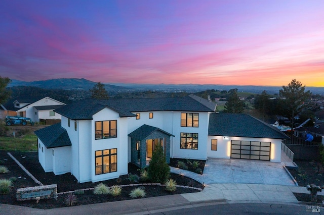 view of front of property with a garage and a mountain view