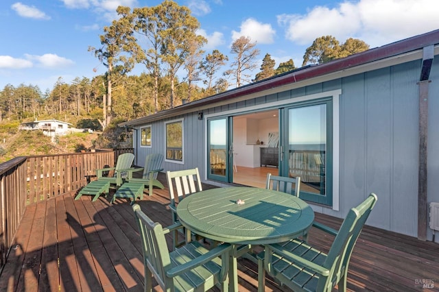 wooden terrace featuring outdoor dining area