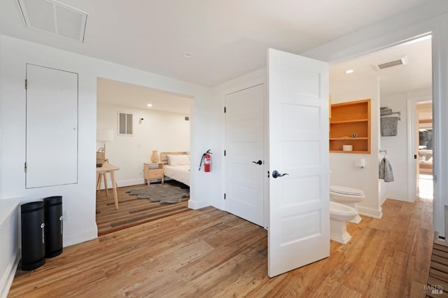 interior space with light wood-type flooring, visible vents, and recessed lighting