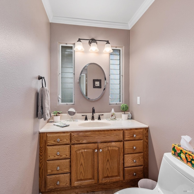 bathroom with ornamental molding, toilet, and vanity