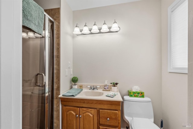 bathroom featuring a stall shower, toilet, and vanity