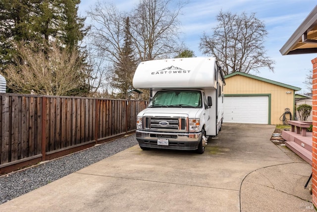 exterior space featuring fence and concrete driveway