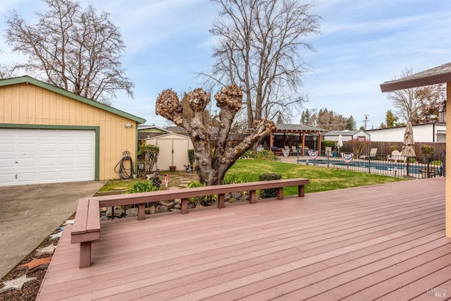 wooden terrace with an outdoor structure, a fenced in pool, and fence