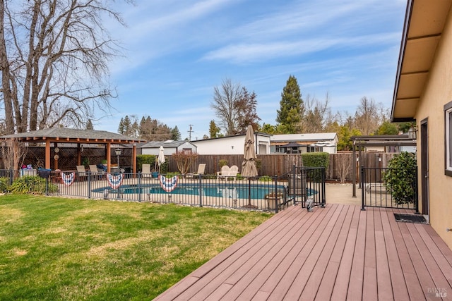 wooden deck with a fenced backyard, a fenced in pool, a patio area, and a yard